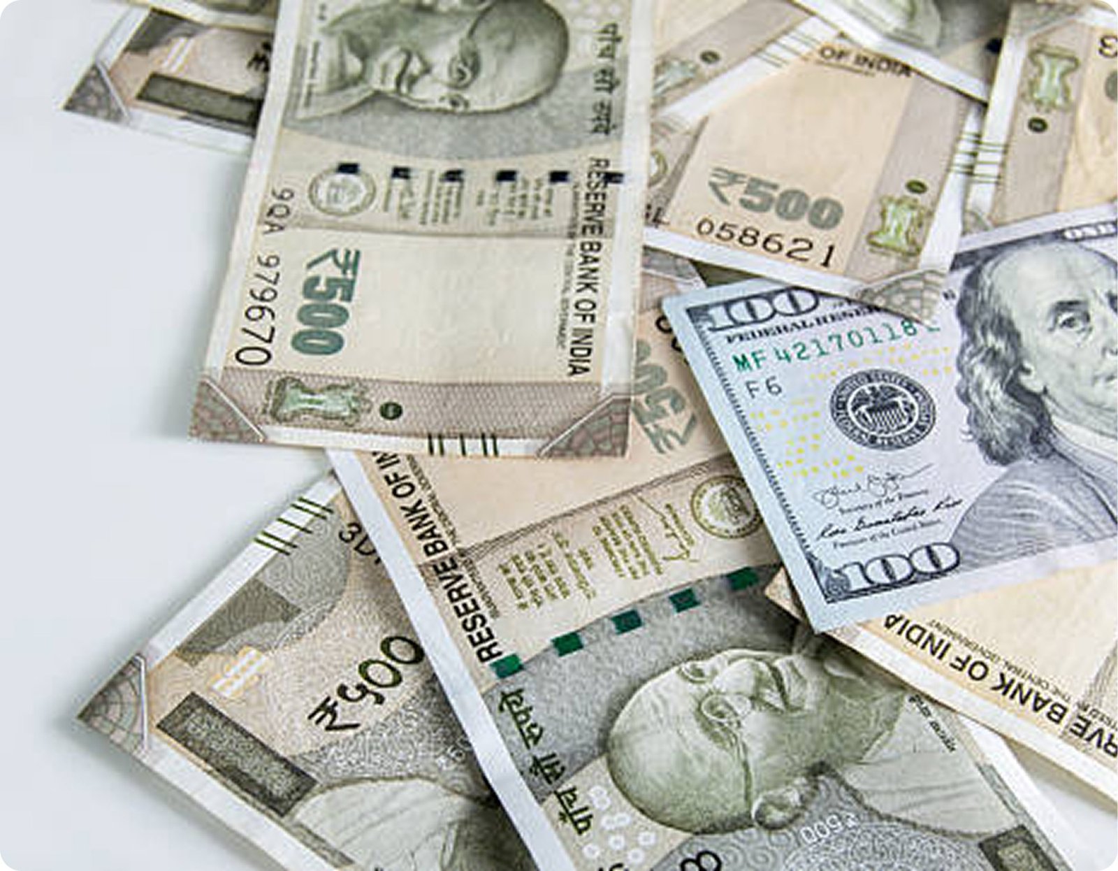 US dollars and Indian rupees on a table